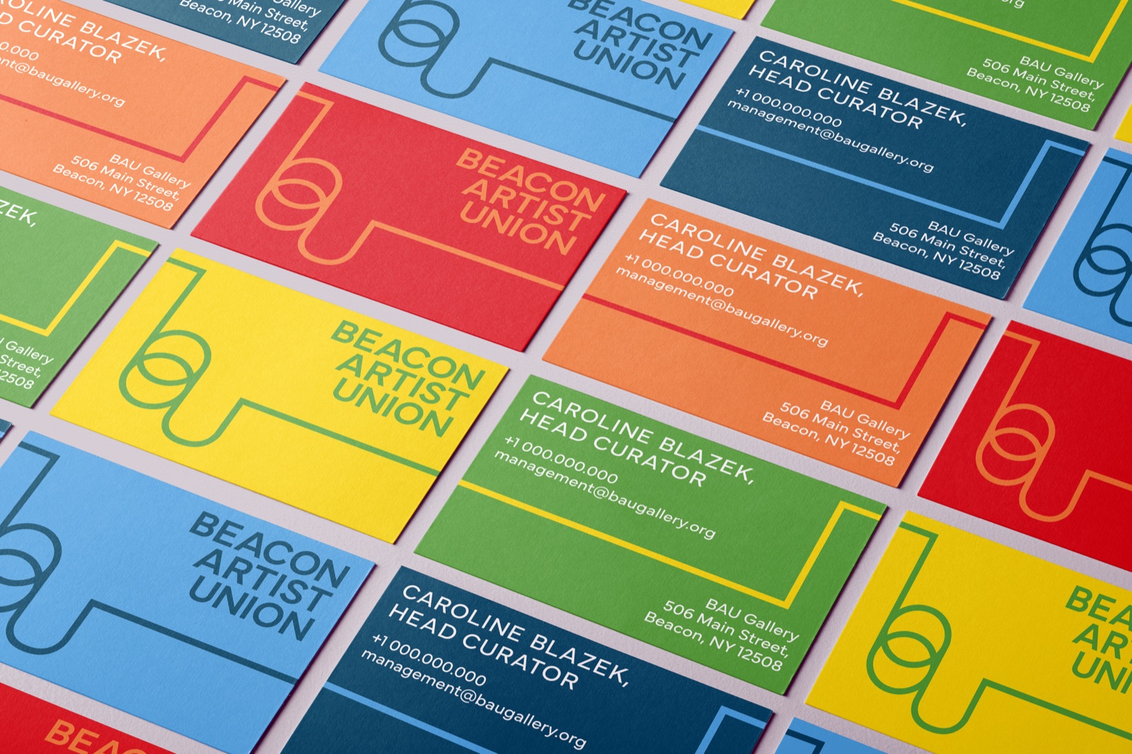 A spread of business cards in the identity’s colors