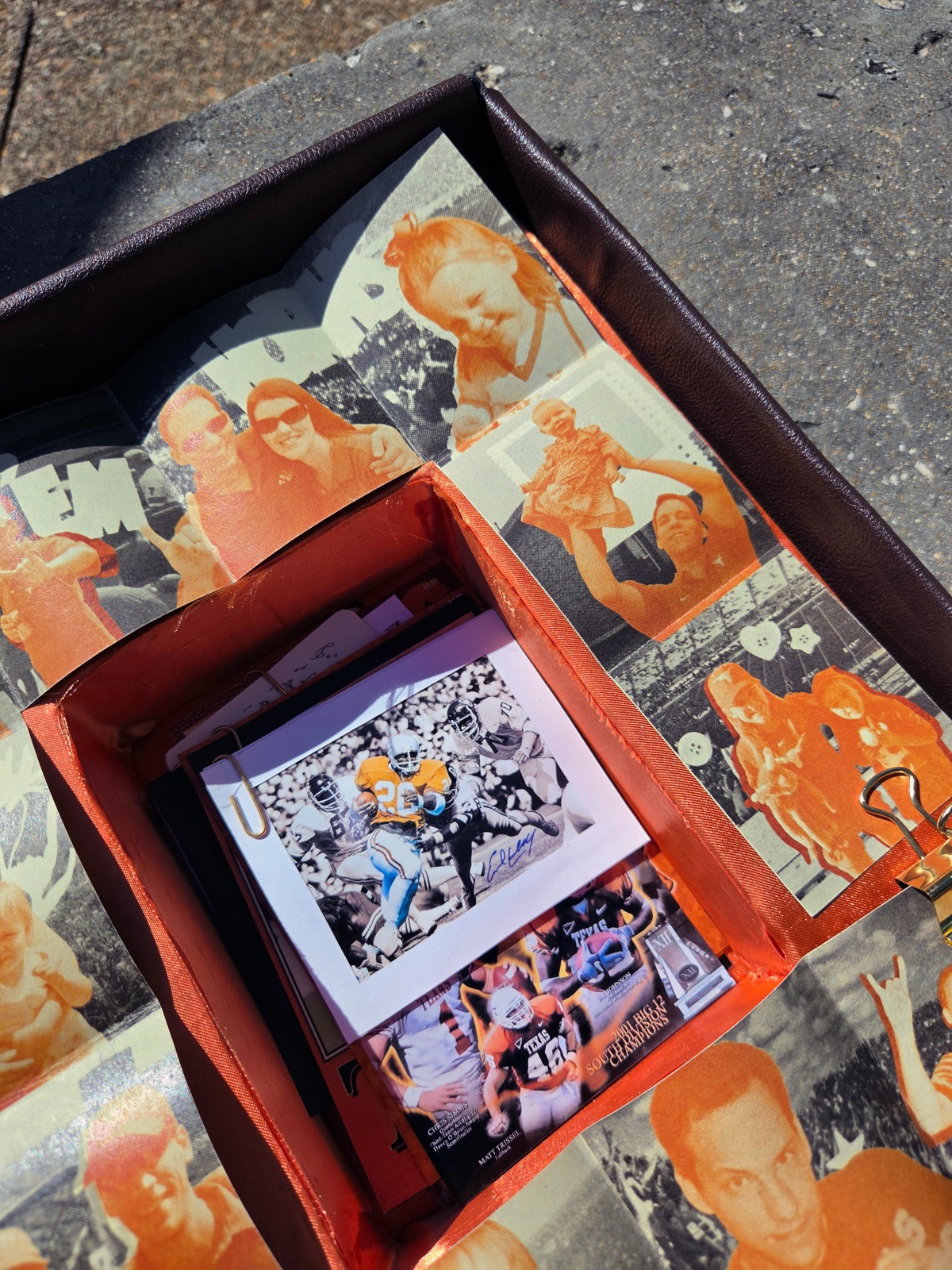Looking down into the inner chamber, a signed photograph resting on the stack of ephemera