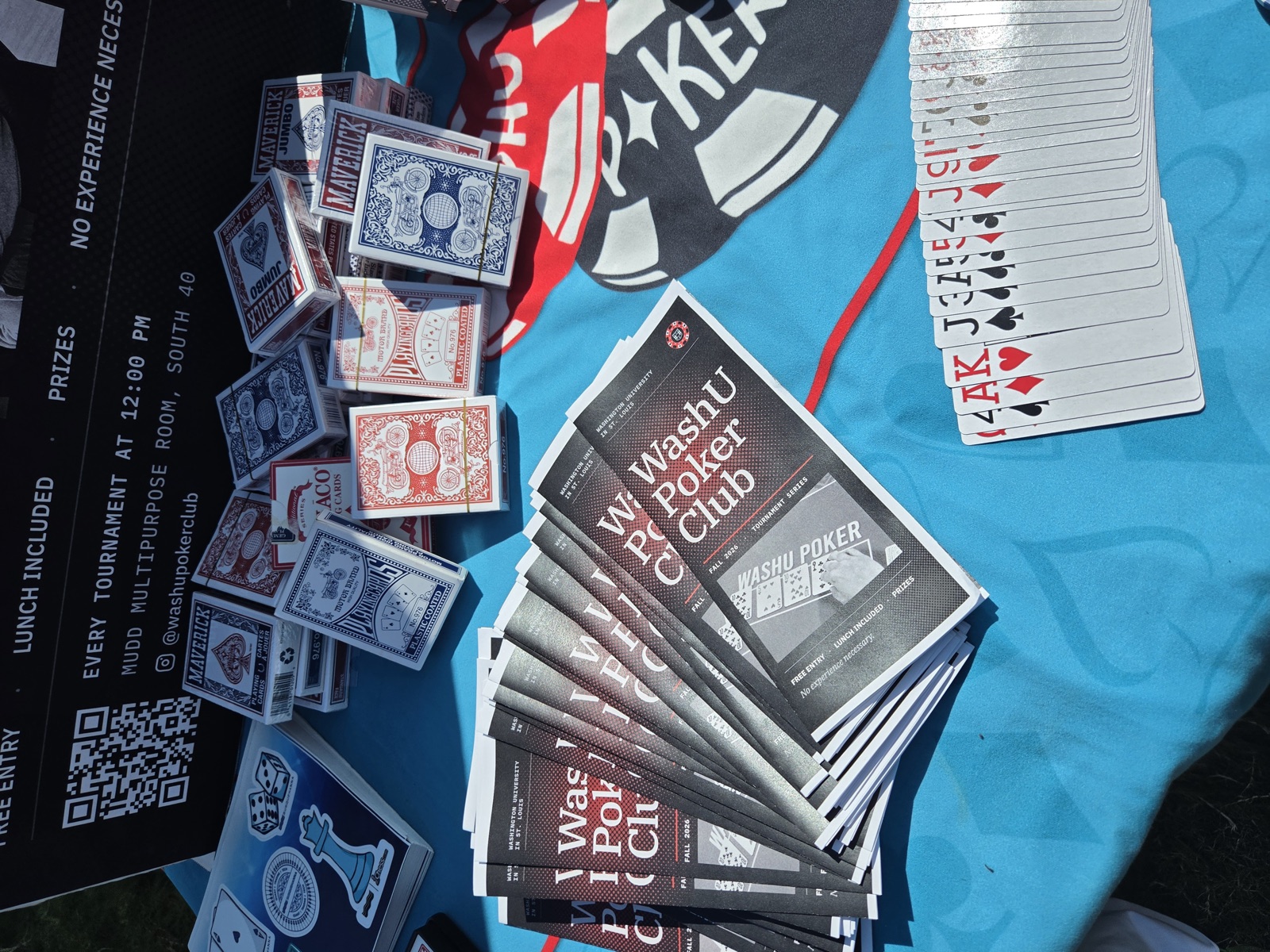 A spread of WashU Poker Club pamphlets and playing cards